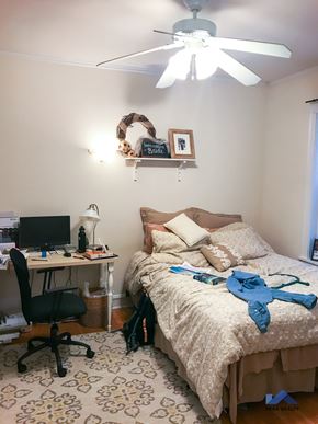 Evanston apartment for rent - a bedroom with a bed and a desk and a ceiling fan